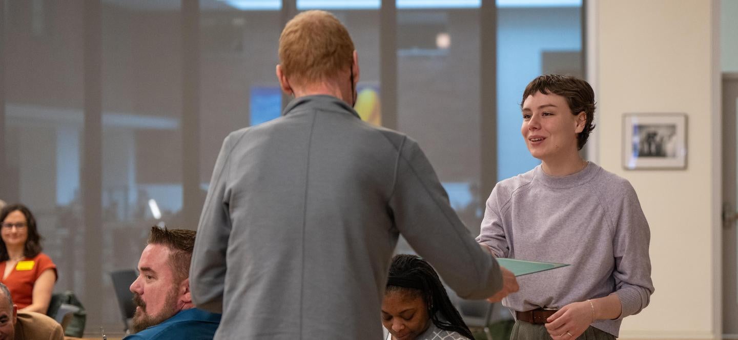 employee shaking hands and receiving a certificate
