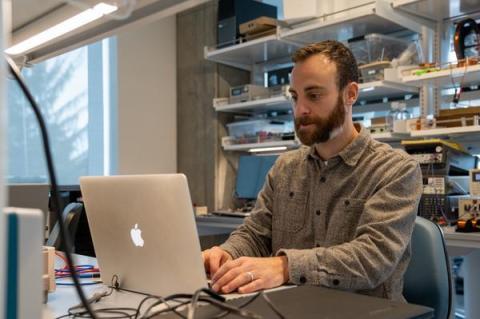 researcher in lab using laptop