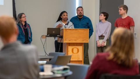 employees presenting at podium
